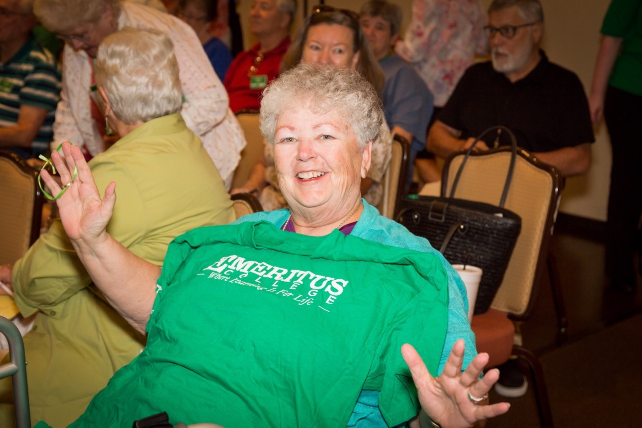 A member displaying an Emeritus College shirt.